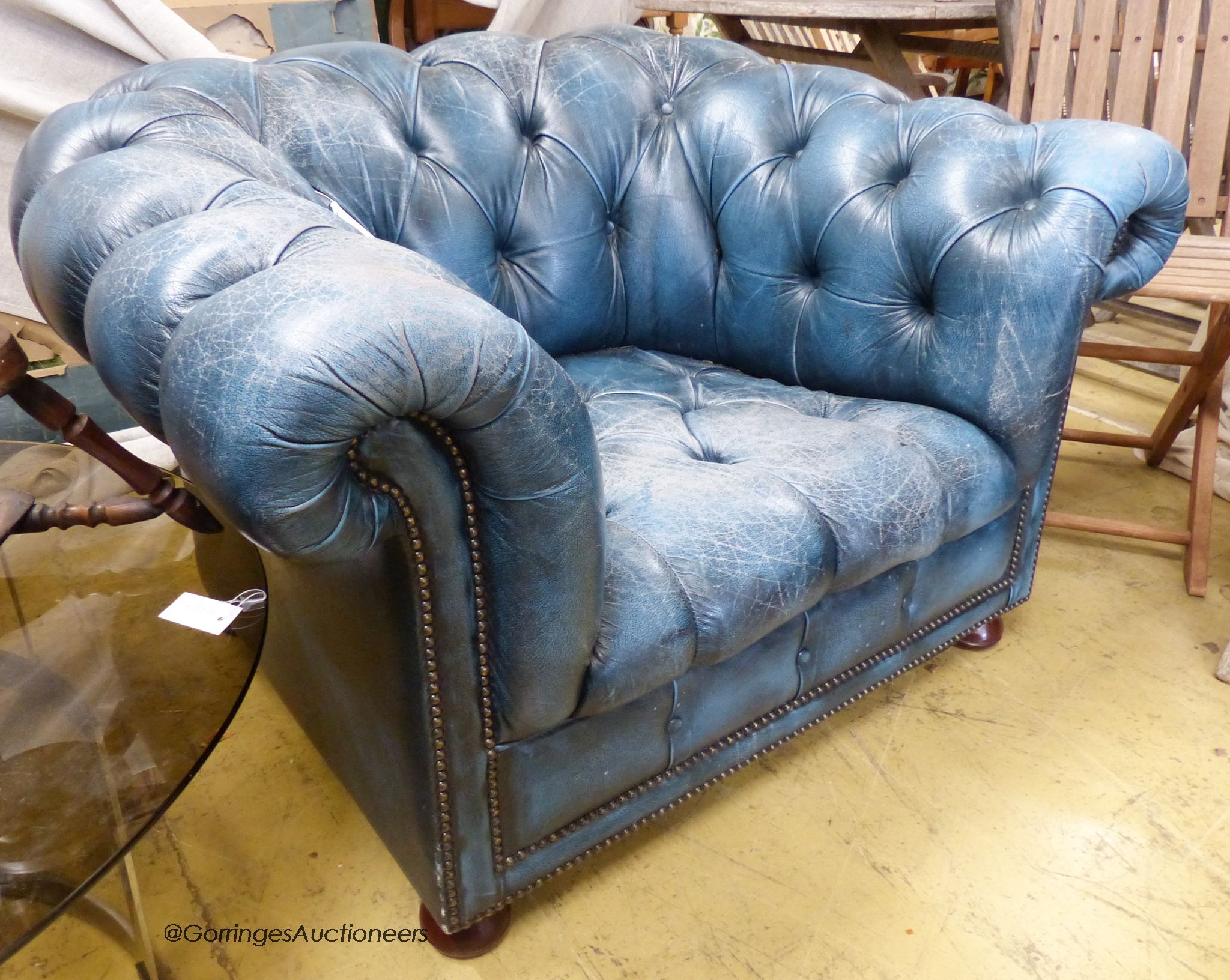 Victorian style, buttoned blue leather chesterfield armchair.